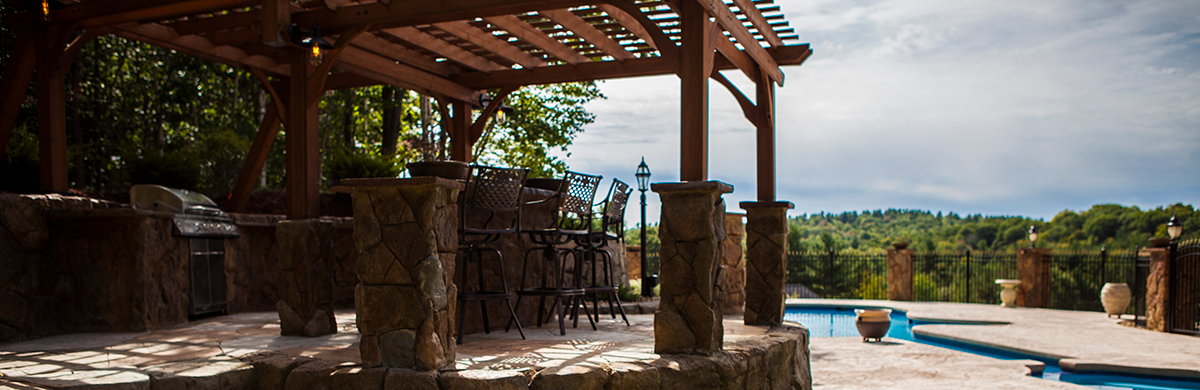 Poolside outdoor kitchen with bar and grill in Madison, WI
